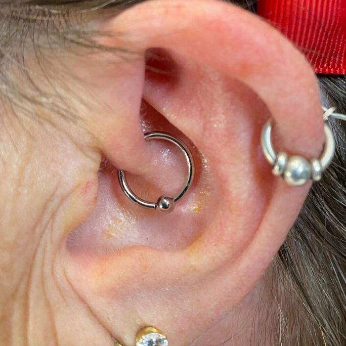 Stacked ear piercings with ring jewelry, done at Adrenaline