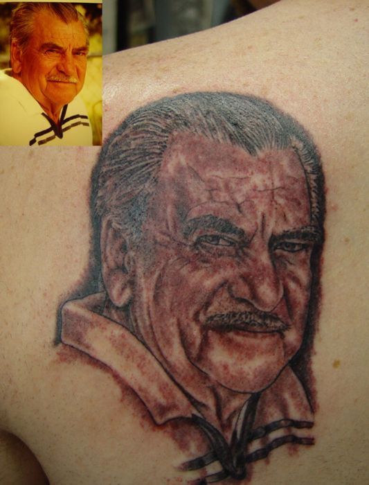 Black and grey portrait tattoo by Steve next to the reference photo